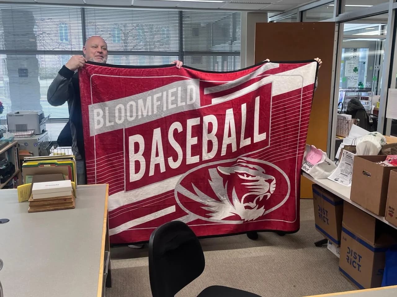 A real free custom sample blanket held up in a school front office